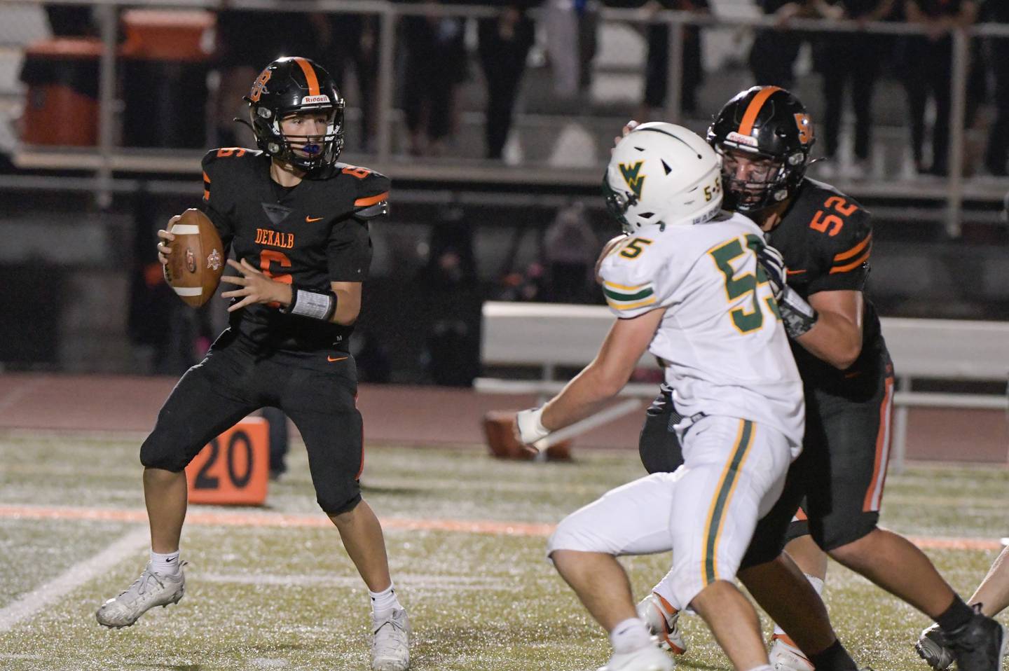DeKalb's quarterback Joshua Klemm (6) looks for an open receiver against Waubonsie during a game in DeKalb on Friday, Oct. 1, 2021.
