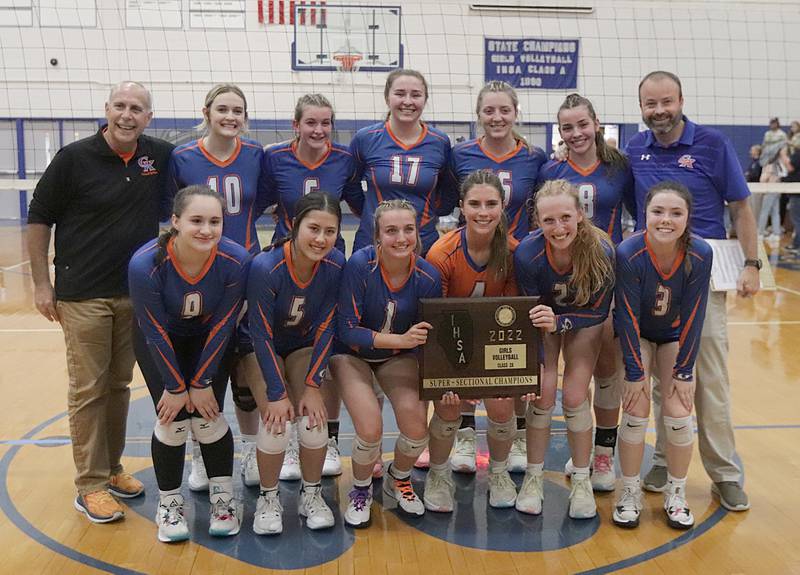 Members of the Genoa-Kingston pose with the Class 2A Supersectional plaque after defeating Quincy Notre Dame in three sets in the Class 2A Supersectional volleyball game on Friday, Nov. 4, 2022 at Princeton High School.