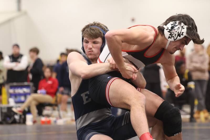 Braeden Grisham of Oswego East pulls down Dominic Recchia of Yorkville in the 138-pound weight SPC Conference championship match at Joliet West on Saturday, Jan 25, 2025.