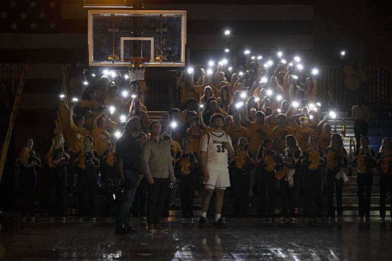 The Sterling High School fans cheer on their team with phone lights at the start of their game against Moline Friday, Dec. 1, 2023.