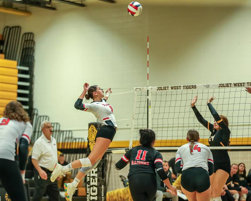 Bolingbrook's Sophia Barrera (5) spikes the ball during regional final volleyball match between Bolingbrook at Joliet West.  Oct 26, 2023.