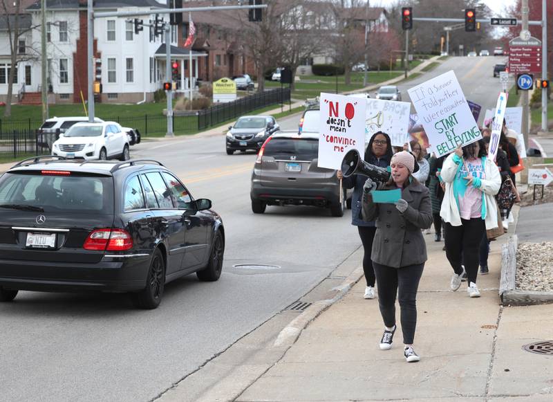 Marchers walk south on First Street Monday, April 7, 2025, during the Safe Passage Take Back the Night and Survivor Speak Out in Dekalb. The event is held in conjunction with Sexual Assault Awareness Month.