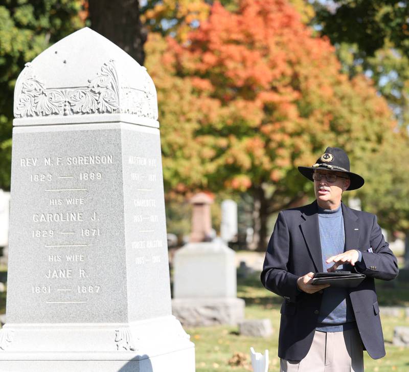 Volunteer Lars Jacobson, talks to visitors Sunday, Oct. 9, 2022, at Elmwood Cemetery in Sycamore, at the grave of Reverend Sorenson, who was an early reverend at St. Peter's Episcopal Church, during the Etched in Stone cemetery walk. The event, hosted by the DeKalb County History Center, told the stories of some local individuals who are buried there.