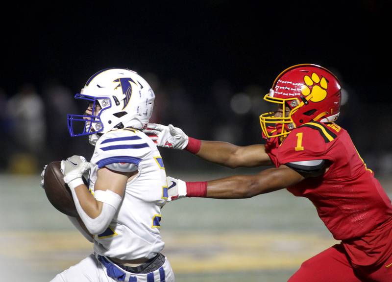 Wheaton North’s Luke Bellini runs the ball away from Batavia’s Brandon Redmond during a game at Batavia on Friday, Sept. 22, 2023.