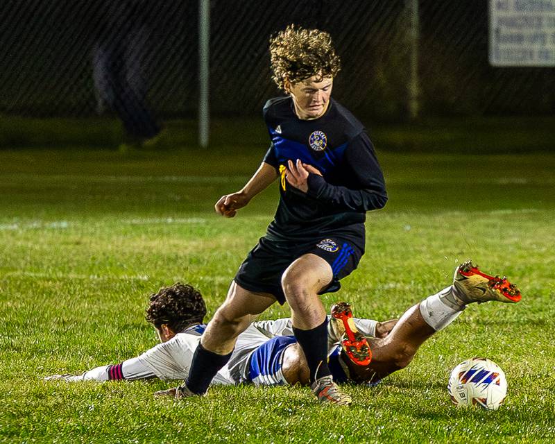 Landon Johnson (20) of Somonauk/Leland/Newark pursues ball after Sawyer Smith (0) of Hinckley-Big Rock falls to floor during the Little Ten Conference Championship match on Thursday, Oct. 9, 2025 at Hinckley-Big Rock School in Hinckley.