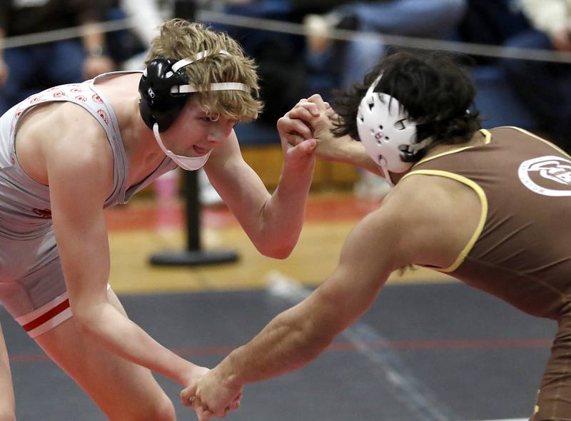 Marian Central's Noah Cerny tries to get position while wrestling Mt. Carmel's Justin Williamson in their 144-pound match during a triangle wrestling meet on Saturday Jan. 11, 2025, between Marian Central, Joliet Catholic, and Mt. Carmel at Marian Central High School in Woodstock.