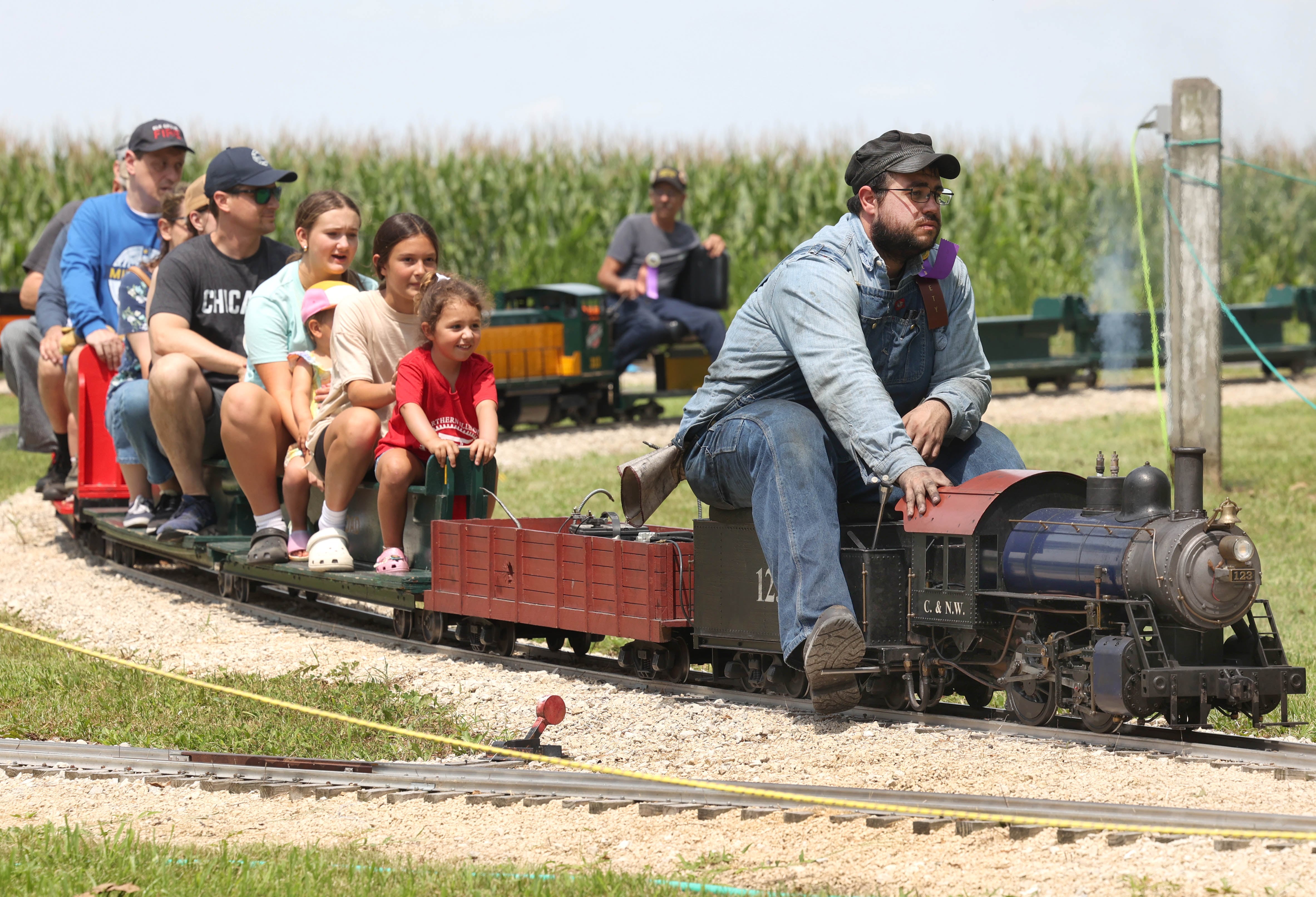 Blake Bushue, from DeKalb, drives a 1/8 scale steam locomotive Thursday, Aug. 8, 2024, during the 67th annual Sycamore Steam Show and Threshing Bee at Taylor Marshall Farm.