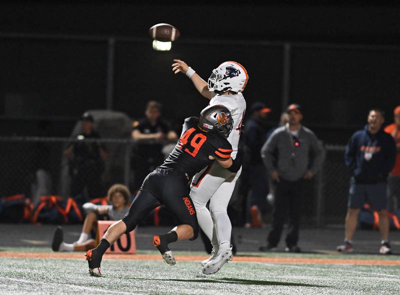 Minooka's Kaden Meyer (49) pressures Oswego's Drew Kleinhans (4) during the conference game on Friday, OCT. 10, 2025, at Minooka.
