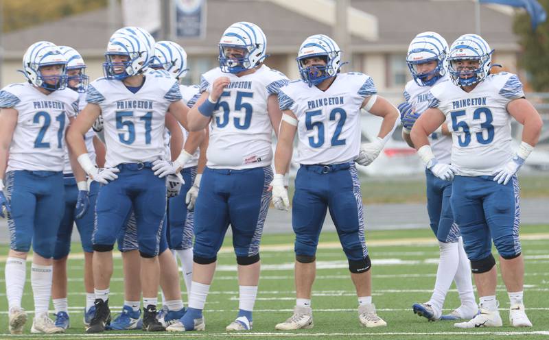 Members of the Princeton football team wait on the field in between plays during the Class 3A playoffs on Saturday, Nov. 1, 2025 at Central Catholic High School in Bloomington.