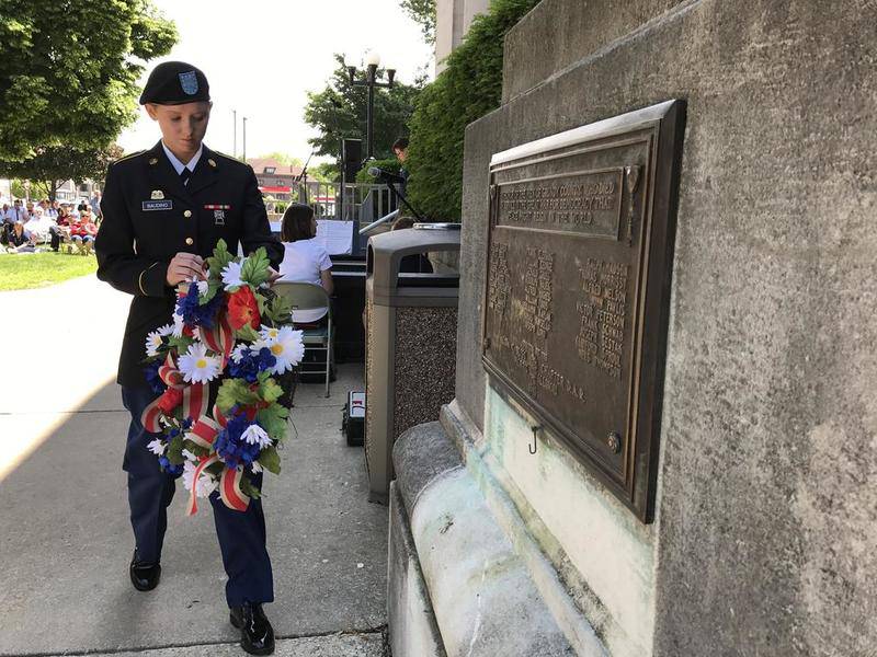Brooklyn Baudino of the Army National Guard, lays a wreath on behalf of the American Legion Post 294 during the Memorial Day event at the Grundy County Courthouse May 29, 2017.