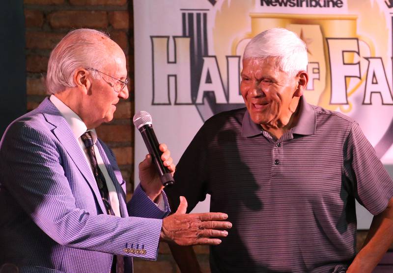 John Cruz, a legendary area baseball coach and recipient of the Lanny Slevin Lifetime Achievement Award chats with emcee Lanny Slevin during the 2025 Shaw Media Illinois Valley Sports Hall of Fame at the Auditorium Ballroom in La Salle.