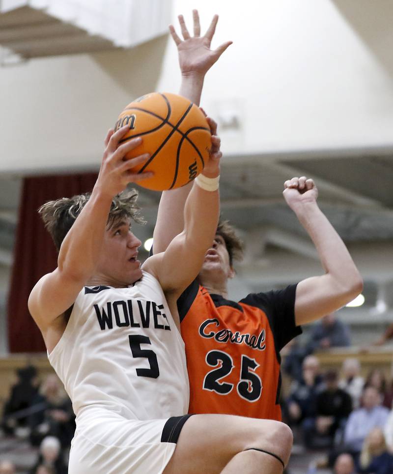 Prairie Ridge's Elijah Loeding drives to the basket against Crystal Lake Central's Aidan Watson during an IHSA Class 3A Prairie Ridge Regional basketball game on Monday, Feb. 24, 2025, at Prairie Ridge High School.