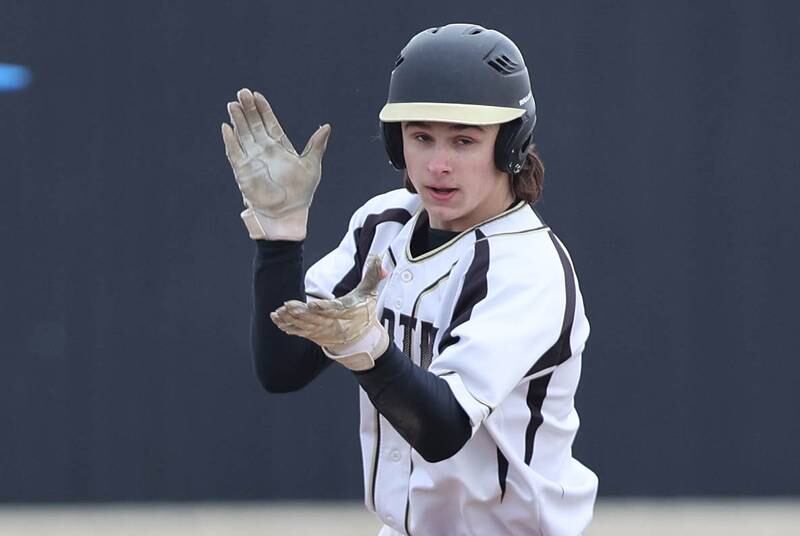 Sycamore's Collin Severson celebrates after his base running resulted in a Sycamore run during their game against Burlington Central Tuesday, March 21, 2023, at Sycamore Community Park.