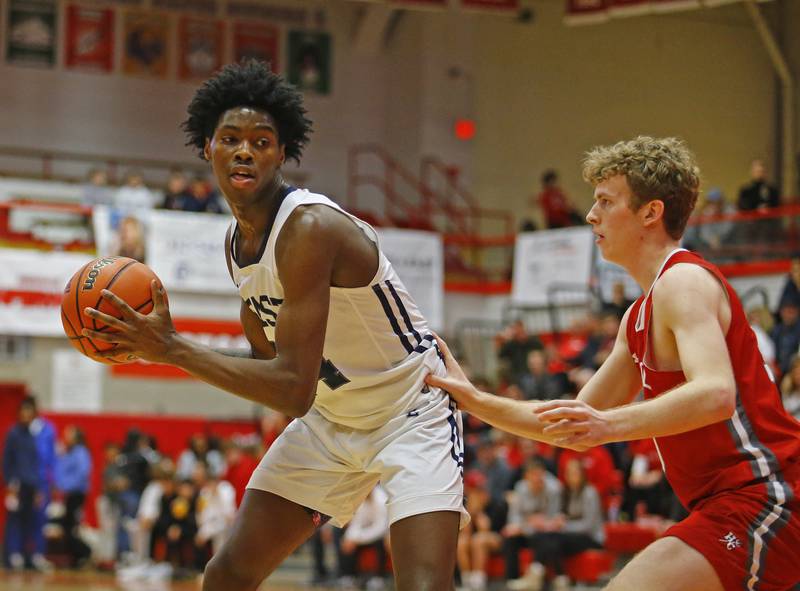 Oswego East's Mekhi Lowery (24) looks to get past the defense during the Hinsdale Central Holiday Classic championship game between Oswego East and Hinsdale Central high schools on Thursday, Dec. 29, 2022 in Hinsdale, IL.