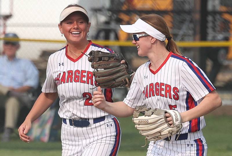 Dundee-Crown's Alyssa Gale (right) gets a fist bump after making a catch from teammate Lily Peters during their game against Sycamore Thursday, May 18, 2023, at Sycamore High School.