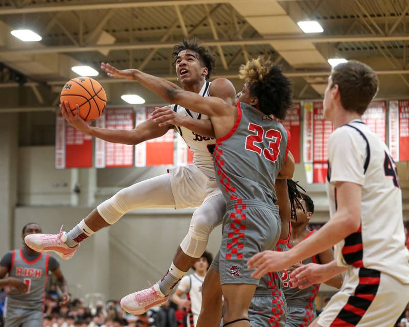 Benet's Blake Fagbemi (0) puts up an acrobatic shot during their When Sides Collide Shootout basketball matchup between Rich Township and Benet Academy. Jan 25, 2025 in Lisle.