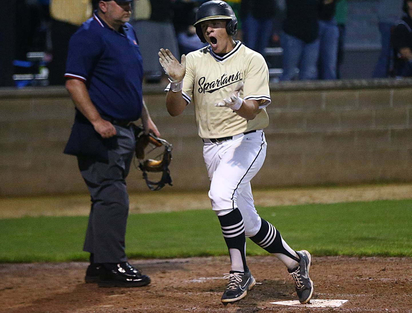 Sycamore's Kiefer Tarnoki reacts after scoring a run against Washington in the Class 3A Supersectional game on Monday, June 6, 2022 in Geneseo.