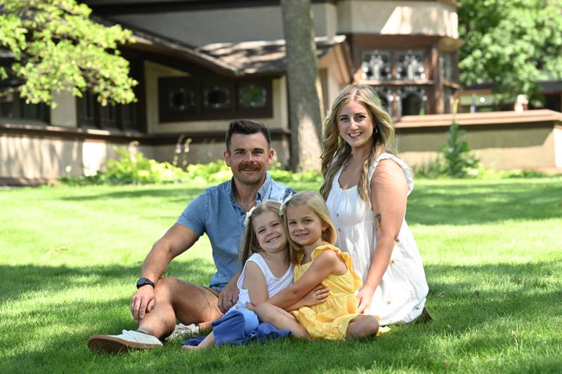The Strysik family, of Bourbonnais, pose for a photo on the lawn of the B. Harley Bradley House in Kankakee. The home will serve as a backdrop for a photoshoot fundraiser for nonprofit Wright In Kankakee.