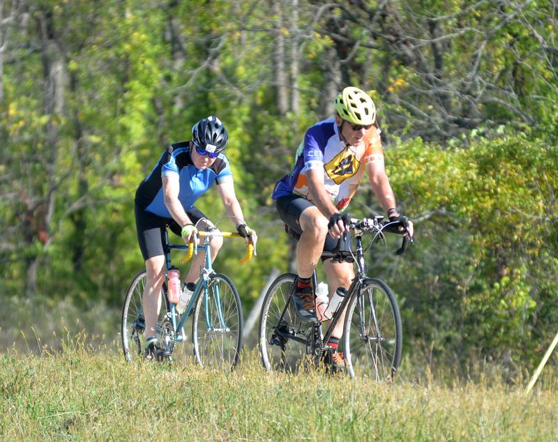 Two bicyclists ride south on Ridge Road during the 10th annual TOSOC (Tour of Scenic Ogle County) on Saturday, Sept. 27, 2025. The event is an annual fundraiser for the Village of Progress in Oregon.
