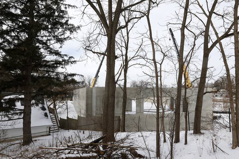 The top of a two-story parking structure, the base of a new apartment complex at the intersection of Northwest Highway and Algonquin Road, is seen Tuesday, Jan. 4, 2022, from the backyard of the Bettendorf Castle in Fox River Grove.  The building was supposed to include a two-story underground parking deck and five residential floors above it, according to Bettendorf Castle resident William Strohl.