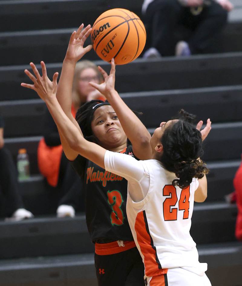 Plainfield East's Gianna Thompson tries to shoot over DeKalb's Nazeria Dean Thursday, Feb. 12, 2026, during their game at DeKalb High School.