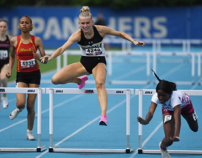 Hinsdale South’s clears the last hurdle on her way to  a third-place finish in the 300-meter hurdles as Belleville West’s Amyjia Robinson falls during the Class 3A girls track and field state meet at Eastern Illinois University on Saturday, May 23, 2026 in Charleston.