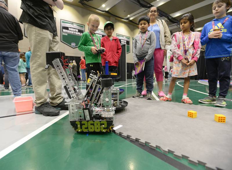 Children including (left) Riley Alhorn of Wheaton get the chance to control the mechanics of a robot during the STEMCON event on Saturday April 26, 2025 at the College of DuPage in Glen Ellyn.