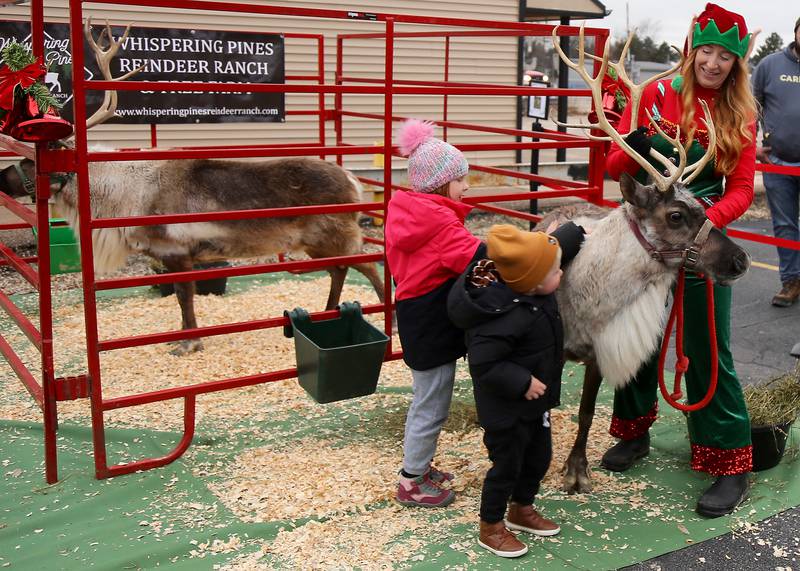 Willow and George Ferguson of Elburn pet Opal the reindeer with the help of Ginergerbells the Elf at the 2023 Elburn Christmas Stroll on Saturday, Dec. 2, 2023.