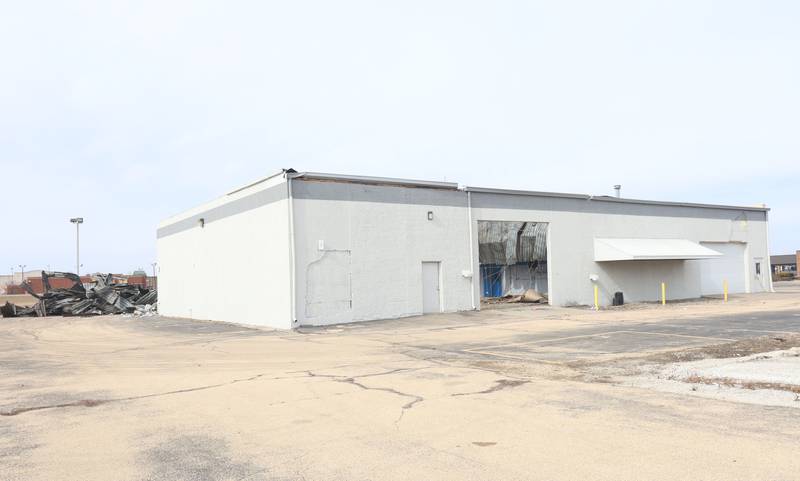An excavator demolishes a portion of the Bill Walsh Coronet Dodge Chrysler Jeep RAM dealership on Tuesday, Feb. 17, 2026 in Peru.