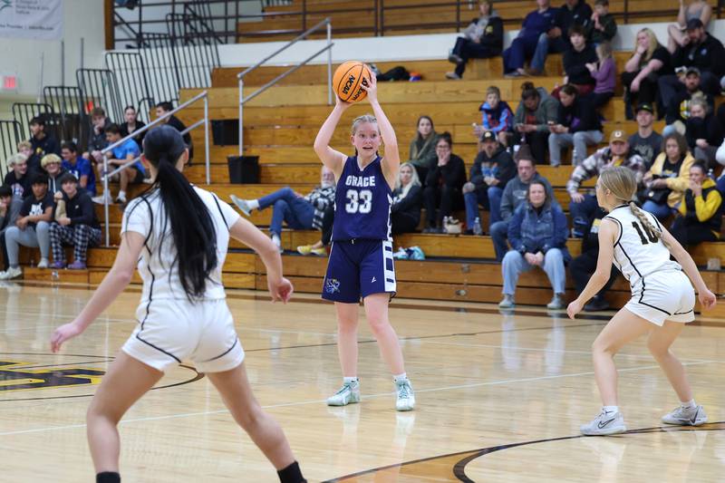 Grace Christian's Annaliese Jorgensen looks to pass around Reed-Custer players during the Comets' 55-24 victory over Grace Christian at the Reed-Custer Classic on Monday, Nov. 17, 2025.