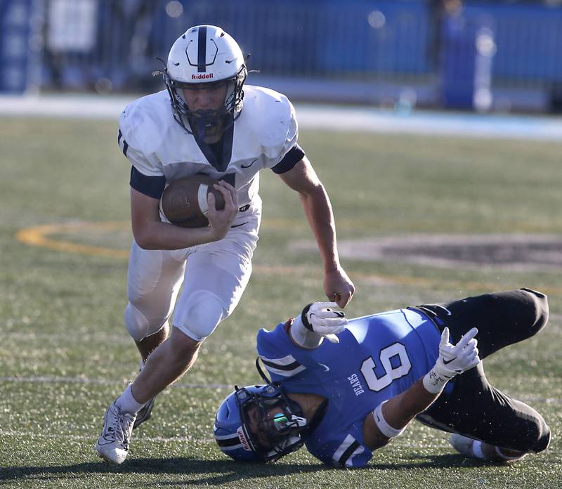 Cary-Grove's Peyton Seaburg runs with the ball after avoiding the tackle of Lake Zurich's George Fotos during a IHSA Class 6A semifinal playoff football game on Saturday, Nov. 18, 2023, at Lake Zurich High School.