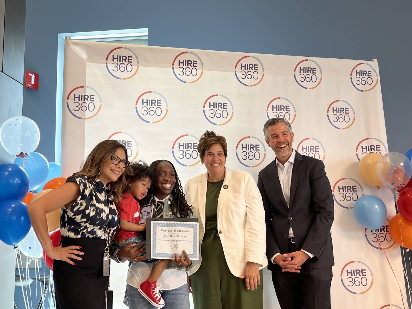 HIRE360 Workforce Development Director AnaMaria Montes de Oca-Rojas (left), Asante McKinney, Will County Executive Jennifer Bertino-Tarrant and HIRE360 Executive Director Jay Rowell at the graduation ceremony for the Illinois Works Pre-Apprenticeship Program in Will County on Wednesday, Aug. 13, 2025, at the Will County Courthouse in Joliet.