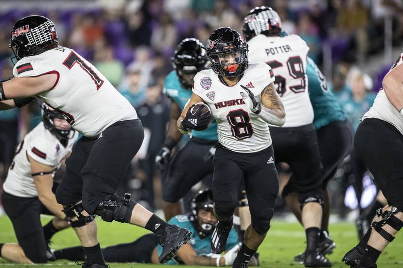 Northern Illinois running back Jay Ducker (8) runs the ball against Coastal Carolina during the Cure Bowl NCAA college football game in Orlando, Fla., Friday, Dec. 17, 2021.