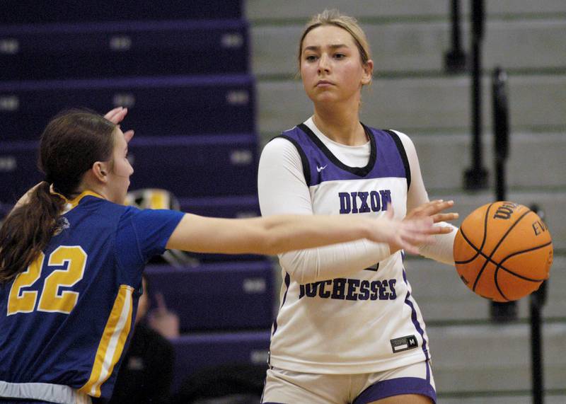 Dixon's  Reese   Dambman brings the ball around Aurora's Reese Schramka. The Dixon Duchesses played  the Aurora Central Catholic Chargers in the Dixon Holiday Tournament at Dixon High School on Friday, December 26th, 2025
