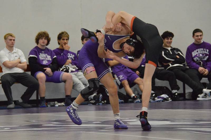 Rochelle's Aiden Lopez (in purple) locks up with a competitor in his match during a dual meet with Morris and Sandwich on January 8.