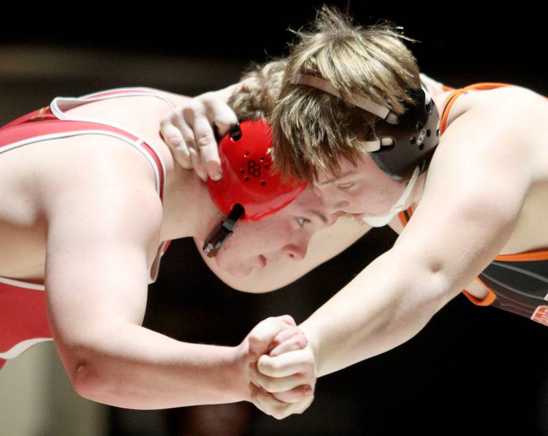 Crystal Lake Central’s Tommy McNeil, right, battles Huntley’s Dylan Cerny in a 215-pound bout in varsity wrestling at Crystal Lake Friday.  McNeil won the match.