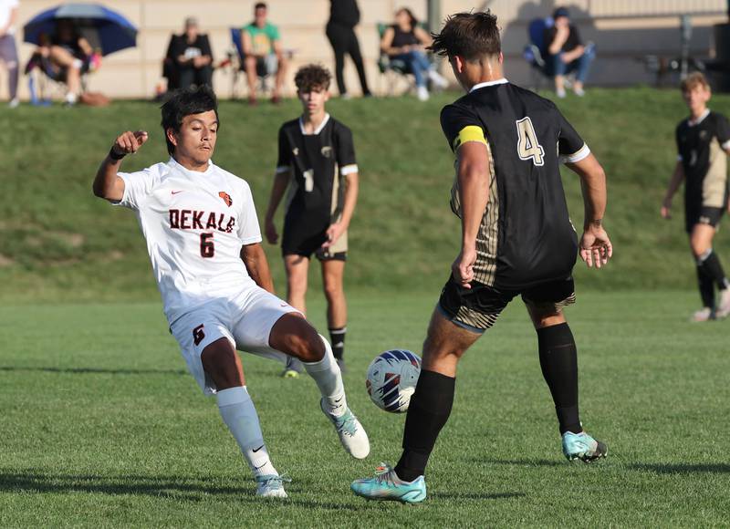 DeKalb's Daniel Blancas tries to get the ball by Sycamore's Ethan Royer during their game Tuesday, Oct. 3, 2023, at Sycamore High School.