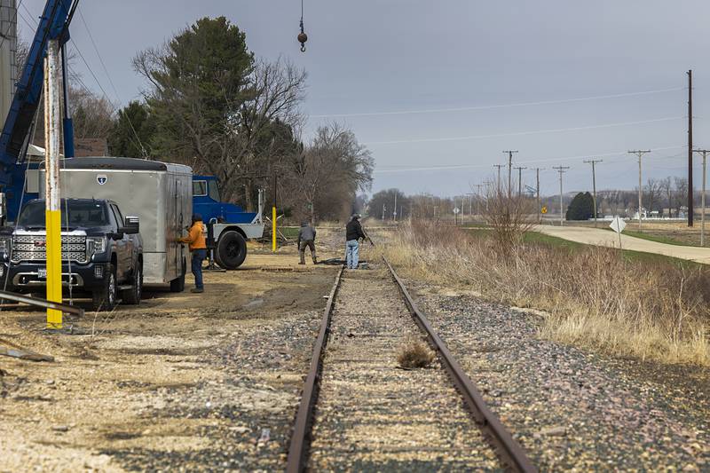 Workers clean up a damaged grain elevator Friday, April 3, 2026, in rural Ogle County.