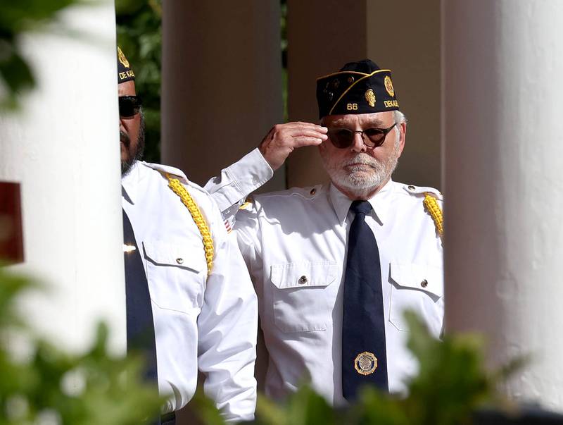 DeKalb American Legion Post 66 Chaplain Mike Giuliano salutes during the singing of the “Star Spangled Banner” Monday, May 26, 2025, during the Memorial Day ceremony at Ellwood House in DeKalb.