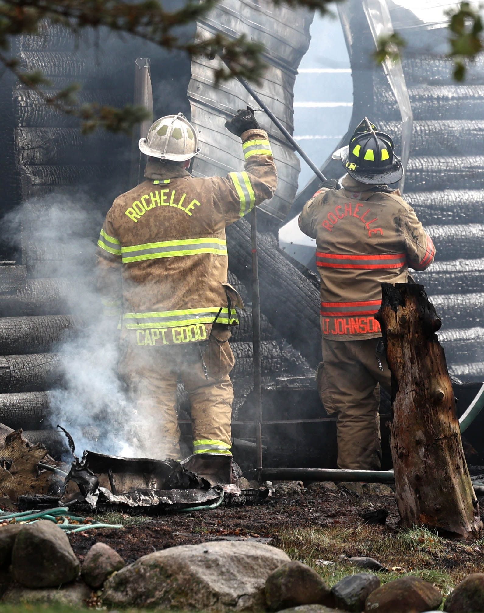 Rochelle firefighters pull down charred debris from a house that was destroyed by fire Thursday, Nov. 13, 2025, near Shabbona Grove Road in Shabbona. Several local departments responded to the general alarm structure fire.