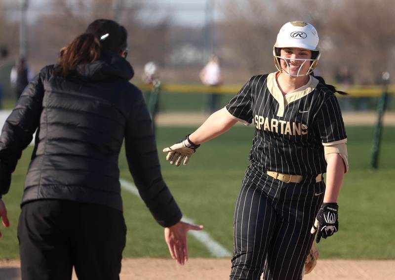 Sycamore's Kairi Lantz is congratulated as she rounds third after hitting a two-run homer Friday, April 11, 2025, during their game against Marengo at Sycamore High School.