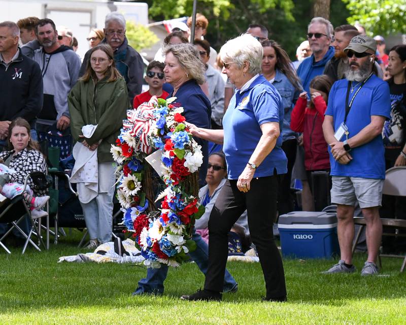 The Woman’s auxiliary presents a wreath at the base of the memorial monument on Monday May 26, 2025, during the Memorial Day event held at Town Square Park in Yorkville.