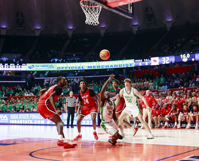 York’s Nathan Poku (21) tries to put up a layup after a hard foul by Marist during the IHSA Class 4A boys basketball state semifinal Friday, March 13, 2026 at the State Farm Center in Champaign.