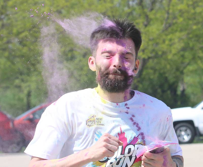 Ruti Artaega of Mendota, gets covered in pink powder as he crosses the finish line during the Color Fun Run on Sunday, April 26, 2026 at Lake Mendota. Artaega got third place at the Color Fun Fun.