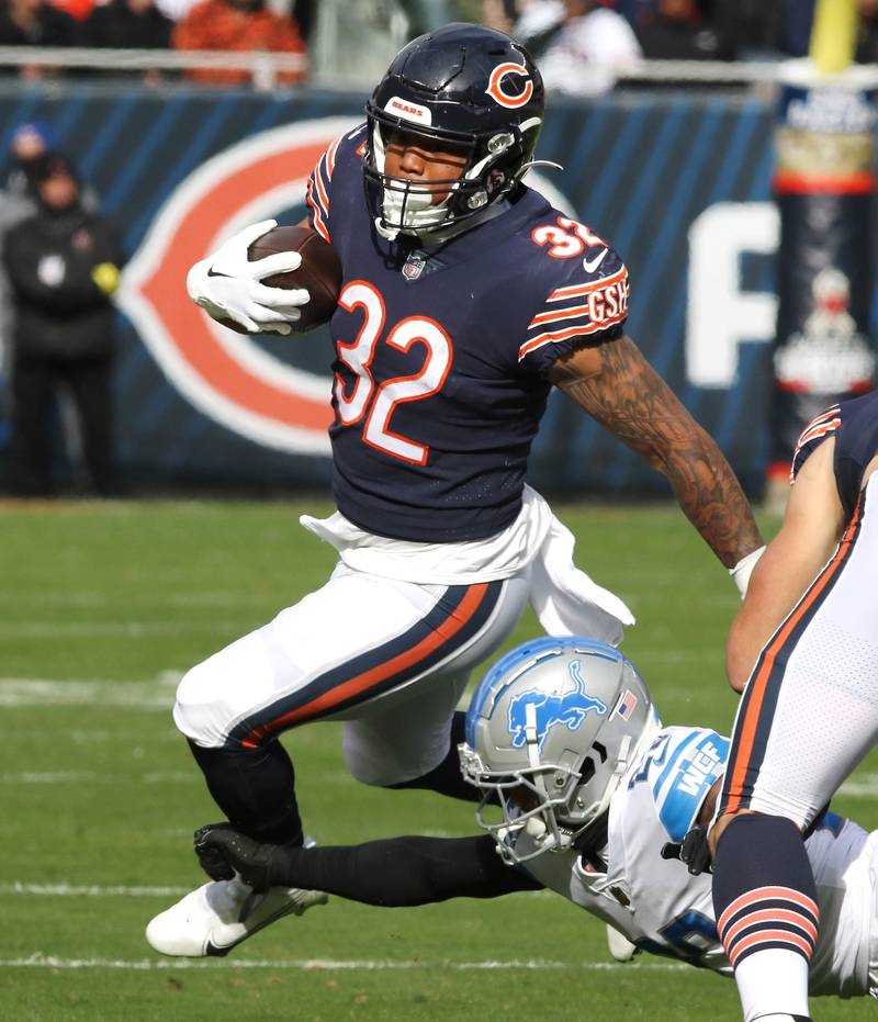 Chicago Bears running back David Montgomery avoids Detroit Lions cornerback Mike Hughes during their game Sunday, Nov. 13, 2022, at Soldier Field in Chicago.