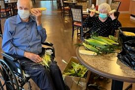 Resthave Care and Rehab residents shuck donated ears of corn