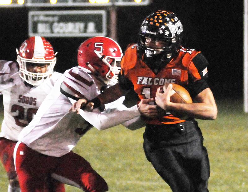 FCW's J.D. Ruddy tries to power through the tackle attempt of South Beloit's Tanner Joiner (5) at the Woodland Wood Shed in an I8FA playoff game Friday, Oct. 29, 2021.