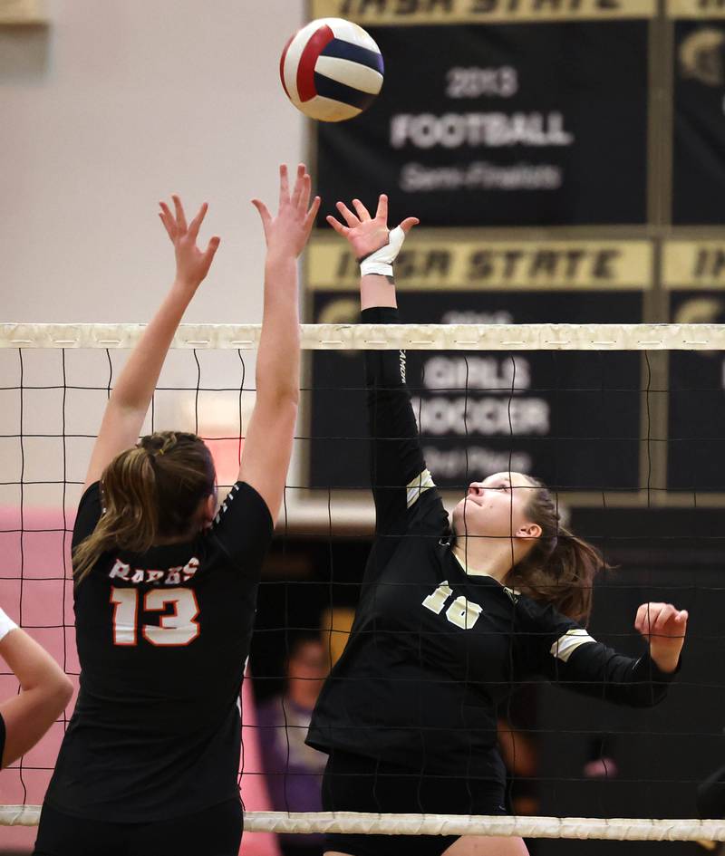 Sycamore's Avery Gerdes and DeKalb’s Isabella Holiday go up for a ball during their match Monday, Oct. 16, 2023, at Sycamore High School.