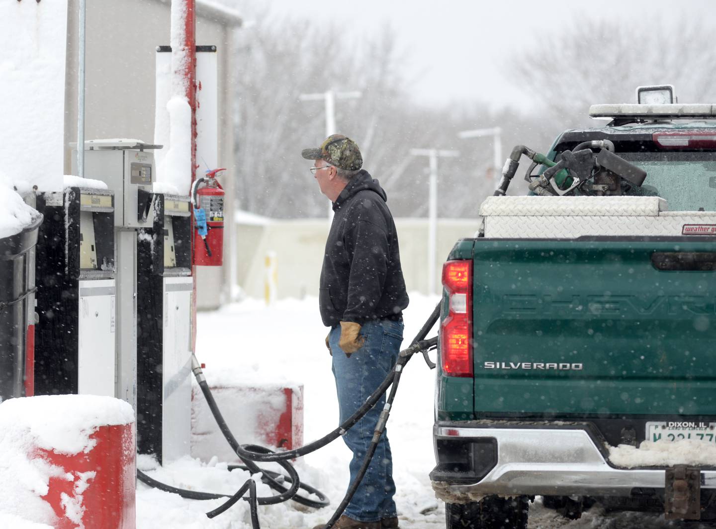 Ogle County Highway employee Dave Boehle fills a fuel supply on his truck before heading out to refuel plow trucks on Friday, Jan. 12, 2024.