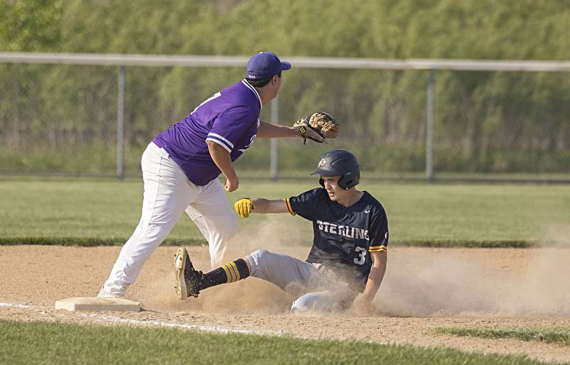 Sterling’s Dylan Ottens slides in safely at third base against Rochelle in class 3A regional action on Monday, May 22, 2023.